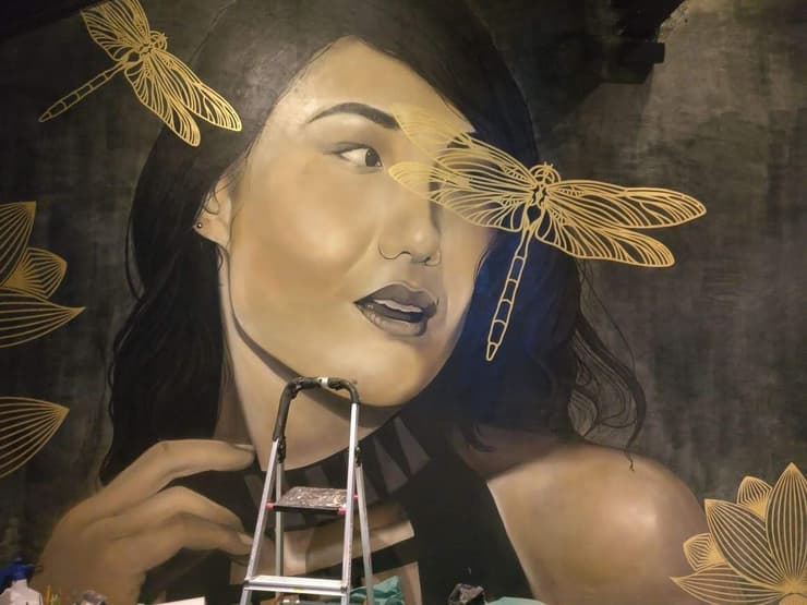 Woman with dragonflies, restaurant wall