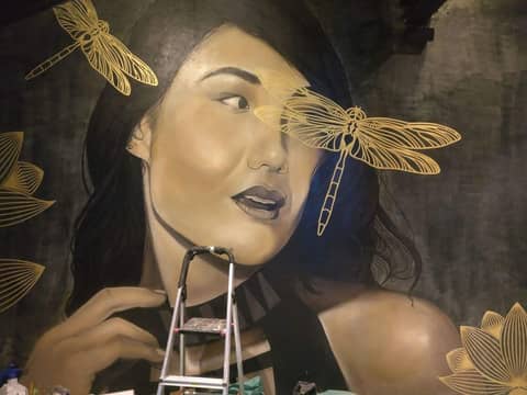 Woman with dragonflies, restaurant wall