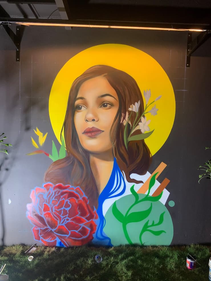 Woman with yellow halo, black wall