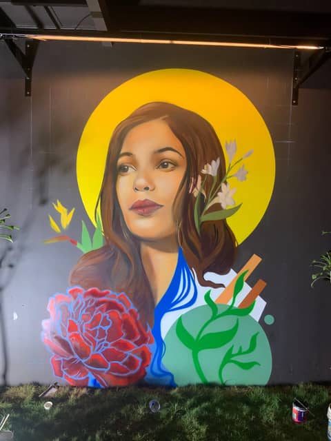 Woman with yellow halo, black wall