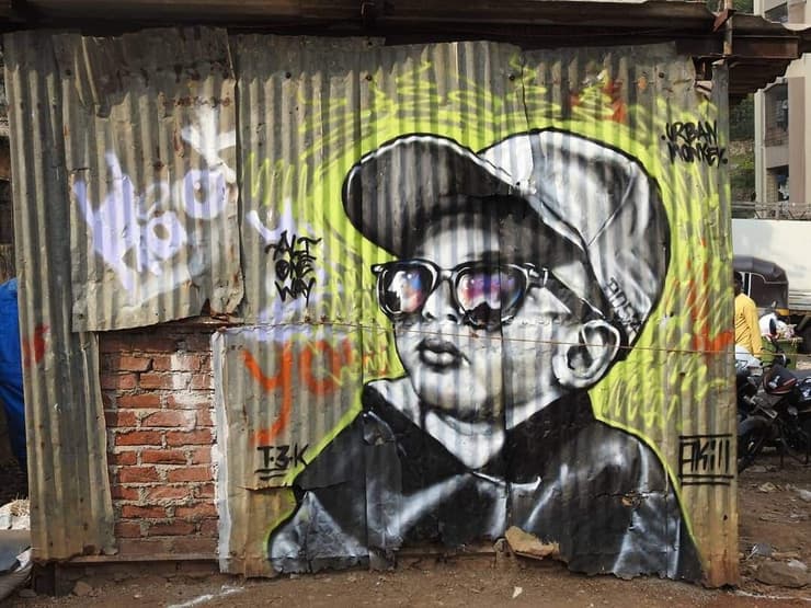 Kid with sunglasses, tin-sheet wall, Marol, Mumbai (hashtags)